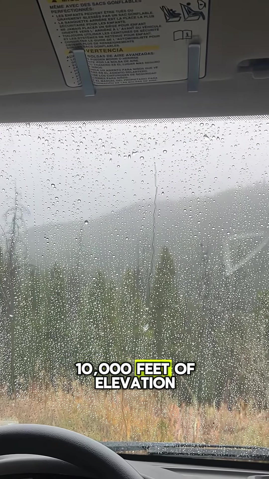 Rain and snow over a van parked at high elevation