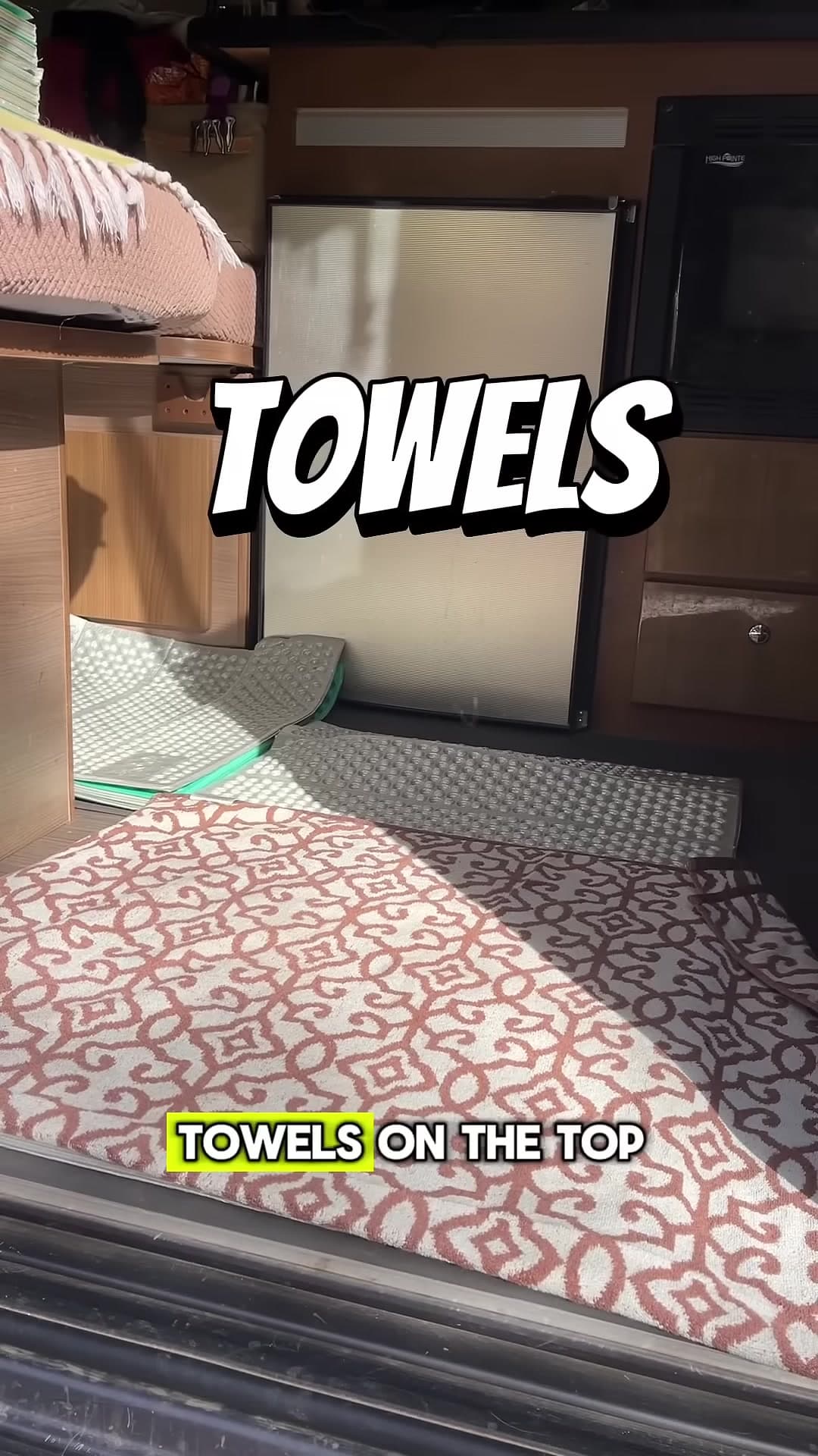 Towels on top of a layered dog floor bed